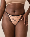 Close-up of the Slippery When Wet script print and thin black elastic waistband