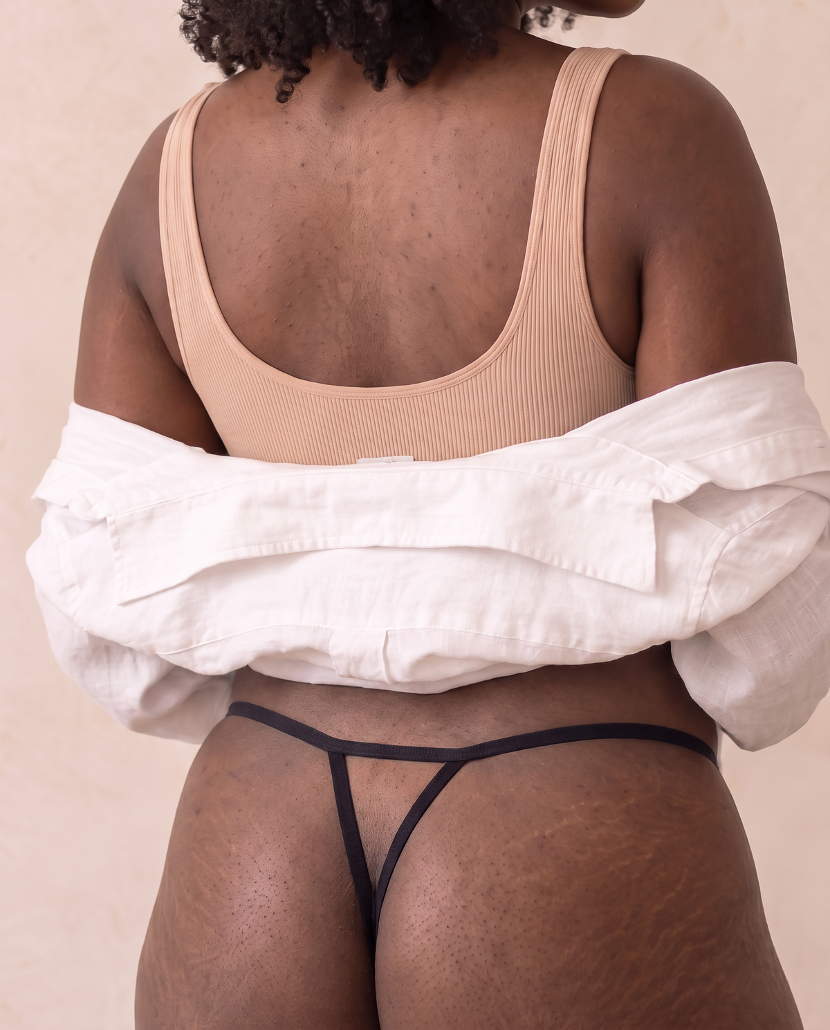 Back view of the Slippery When Wet thong showing the plain black open Y-back string